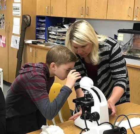 5th grader using microscope