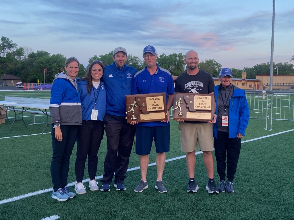 Track coaches holding Championship state track trophies